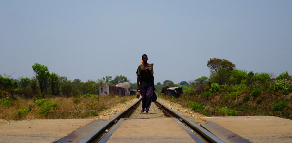 Man walking along railway